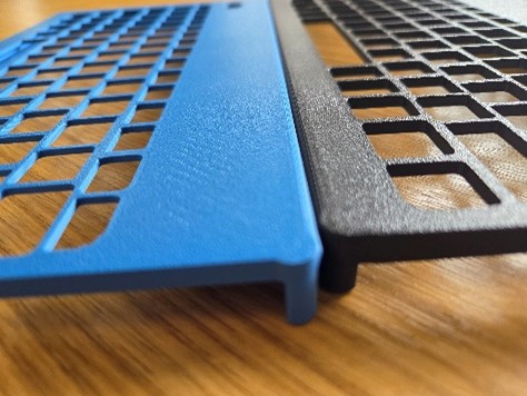 Blue and black keyguards on a wooden surface