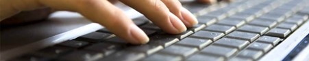 a pupil typing on a keyboard